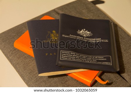 Australian passport on top of orange notebook, getting ready for a holiday