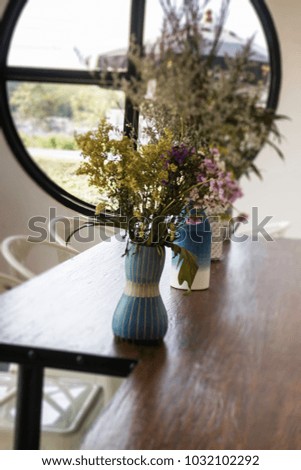 Beautiful flower vase decorated on wooden table, stock photo