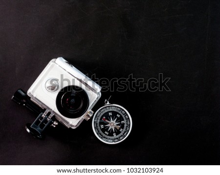 Action Camera with compass on black background.