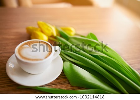 Coffee and flowers at the table. Spring concept, women`s day.