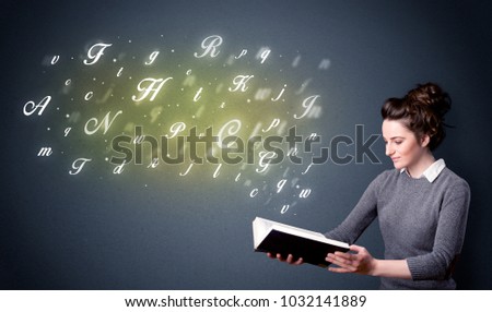 Casual young woman holding book with shiny letters flying out of it