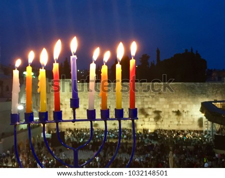 Hanukkah - Jewish Festival of Light in Jerusalem.  Menorah Hanukkiah in foreground, Western Wall / Kotel in background.