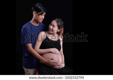 Abdominal woman with abrasive studio lighting in black background