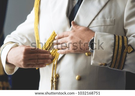 Military man arranging his protocol suit
