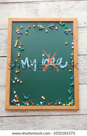 Push Pin and ideas and concept written on chalkboard. This is a vintage photo to use for educational background. 