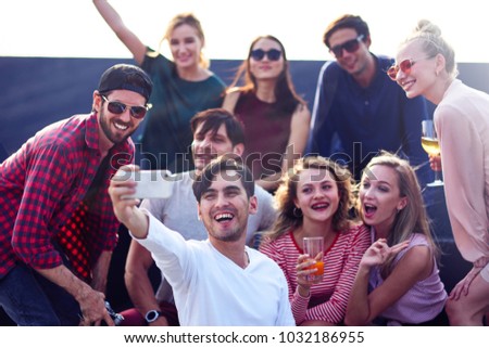Say cheese. Joyful young friends enjoying the party while making selfies
