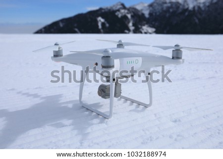 drone ready to take off at ski piste on winter mountain top