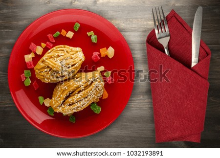 cake with sweets on a wooden background .cake with sweets on a plate top view