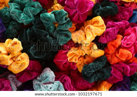 Colorful elastic rings. Girl elastic fashion band. hair scrunchy. A scrunchie is a fabric covered rubber band hair used to fasten long hair. Royalty-Free Stock Photo #1032197671