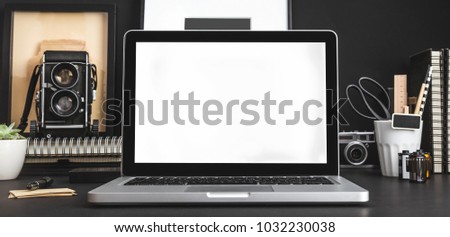 Black artist or designer workspace with laptop mock up and medium format camera. 