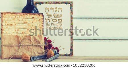 Pack of matzah or matza, Passover Haggadah and Kosher red wine on a vintage wood background. Jewish Passover holiday composition with copy space.Hebrew text translation: The story of Passover

 Royalty-Free Stock Photo #1032230206