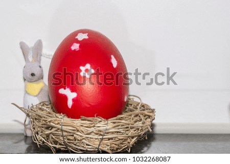 Colorful red easter egg in nest