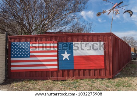American and Texas flags pattern on wooden board texture under blue cloud sky. Vintage painted USA symbols texture on grunge neighborhood wall fence, wintertime. Room for text, copy space