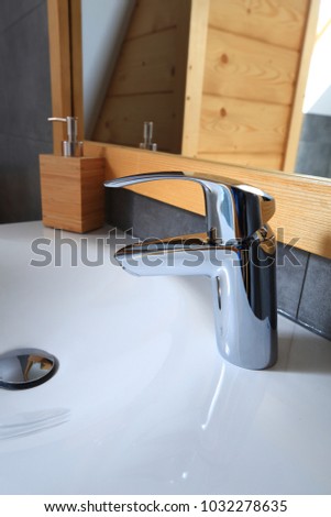 New shiny water tap close-up. Elements of new modern bathroom.
