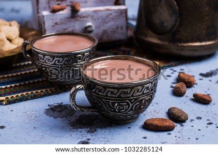 Traditional hot cocoa in a mug on the table. Selective focus.