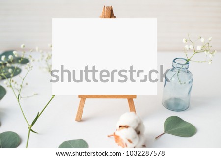 Top view photo. Mockup on a wooden background  with gentle flowers and plants. Cute feminine mockup. Blog header image. Blank space. Card template. 