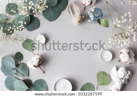 Flat lay top view photo. Mockup on a grey background  with gentle flowers and plants. Cute feminine image. Blog header image. Blank space.