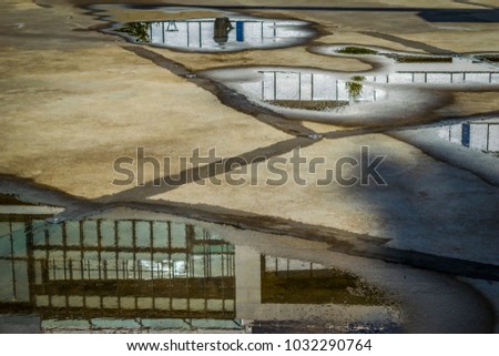 Building reflection in a puddle, after rain.
Puddle with reflection of a modern building facade in Budapest, Hungary.
 Royalty-Free Stock Photo #1032290764