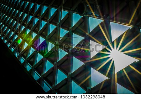 Sun shines through triangular windows. Royalty-Free Stock Photo #1032298048