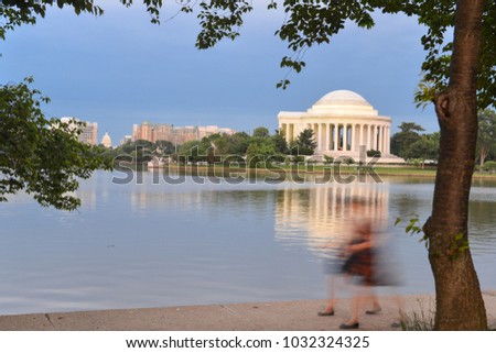 Jefferson Memorial and jogging people in motion blur at night