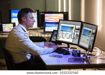 Side View Of A Male Designer Editing Photo On Computer