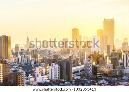 Asia Business concept for real estate and corporate construction - panoramic modern city skyline aerial view of shinjuku area with shinkansen railway under sunset sky in Tokyo, Japan