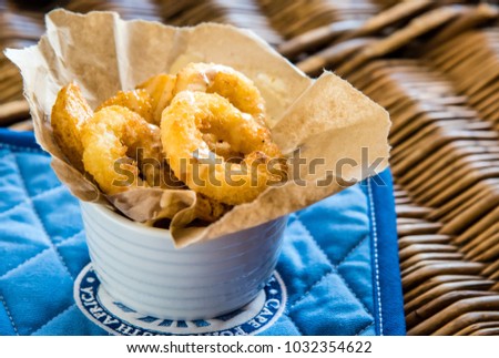 Fried calamari rings and chips, top view macro photo, food photography. Royalty-Free Stock Photo #1032354622