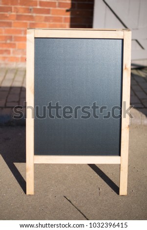 blank blackboard outdoors with space for caption