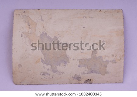 Vintage and antique art concept. Front view of blank old aged dirty photo frame texture with stains and scratches isolated on abstract blurred white background. Detailed closeup studio shot.