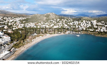 Aerial drone bird's eye photo of famous Vouliagmeni in south Athens riviera with turquoise clear waters, Greece