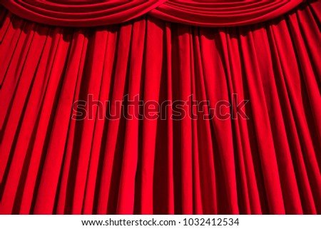 Red curtain theater background with folds, shadows and highlights. Royalty-Free Stock Photo #1032412534