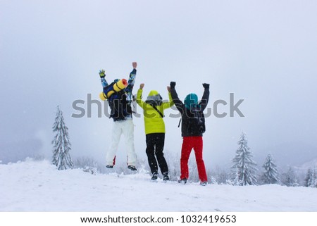 Happy mountaineers at the top of the mountain, winter season
