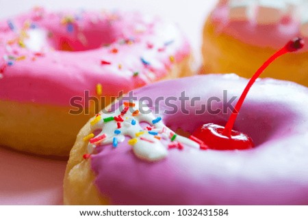 Purple and Pink Donuts On Pink Background