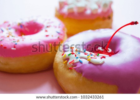 Purple and Pink Donuts On Pink Background
