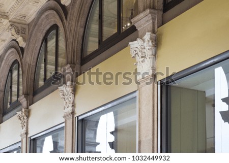 Horizontal front view detail of long empty square store signage on clothes shop building with classical architecture