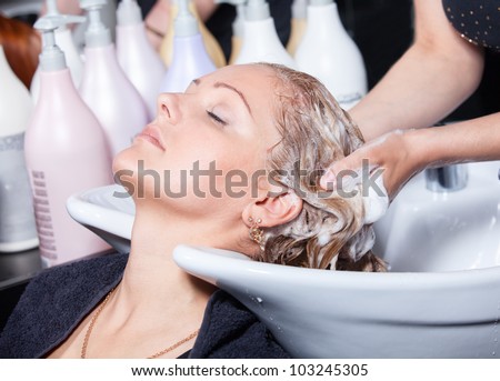 hair washing at a hairdressing salon, young caucasian girl Royalty-Free Stock Photo #103245305