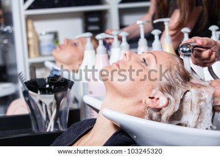 hair washing at a hairdressing salon, young caucasian girl Royalty-Free Stock Photo #103245320