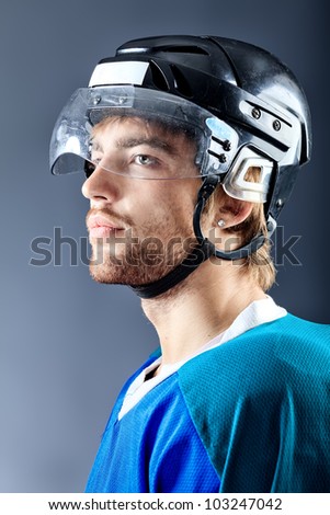 Portrait of a handsome ice-hockey player. Studio shot.