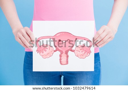 woman take uterus billboard on the blue background