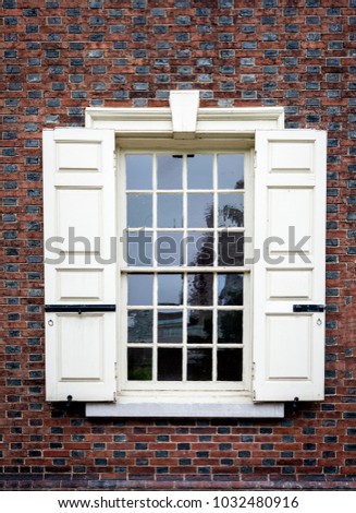 Very old wooden framed window on a red brick building