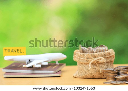 Saving planning for Travel budget of holiday concept,Financial,Stack of coins money in bag and airplane on passport with natural green background