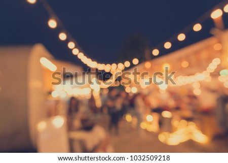 Abstract blur people in night festival city park bokeh background - vintage tone