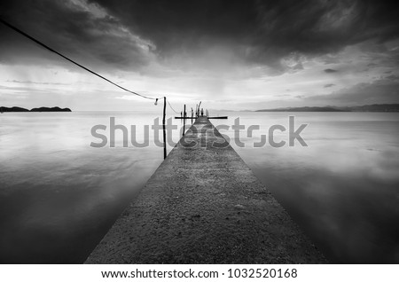 Beautiful fine art image in black & white of abandon jetty at Pulau Pinang, Malaysia. Soft Focus due to long exposure.