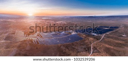 Sunrise over a very panoramic view of photovoltaic panels