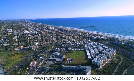 North county San Diego Oceanside pier and surrounding suburbs, business, parks, and highways, with views of Carlsbad and the Pacific Ocean.