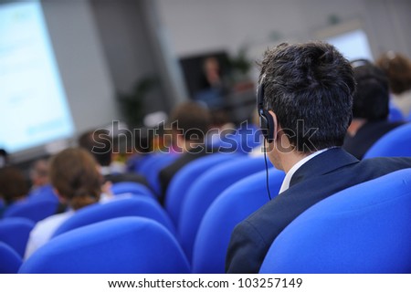 Group of business people attending press conference or presentation. Royalty-Free Stock Photo #103257149