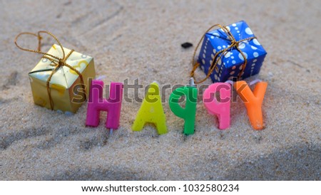 The words 'Happy' in the sand 