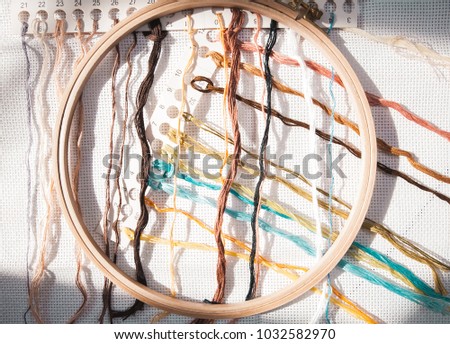 Beautiful embroidery threads on a canvas with a hoop a magnificent background for a hobby