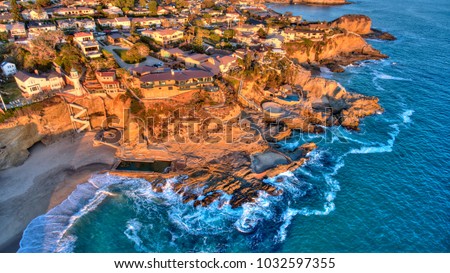 Aerial view of Three Arch Bay in Laguna Beach, Orange County, California during twilight. Royalty-Free Stock Photo #1032597355
