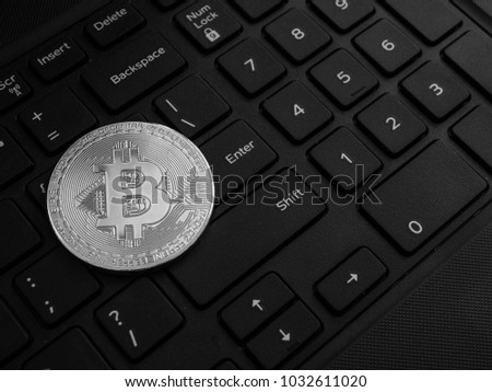 Coin crypto currency bitcoin lies on the keyboard background theme gold exchange pyramid for money due to rise or fall exchange rate closeup